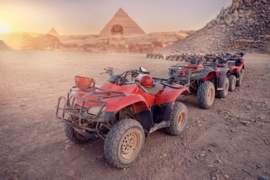 Quad bikes ATV safari in desert background Pyramids Sphinx Cairo, Egypt.