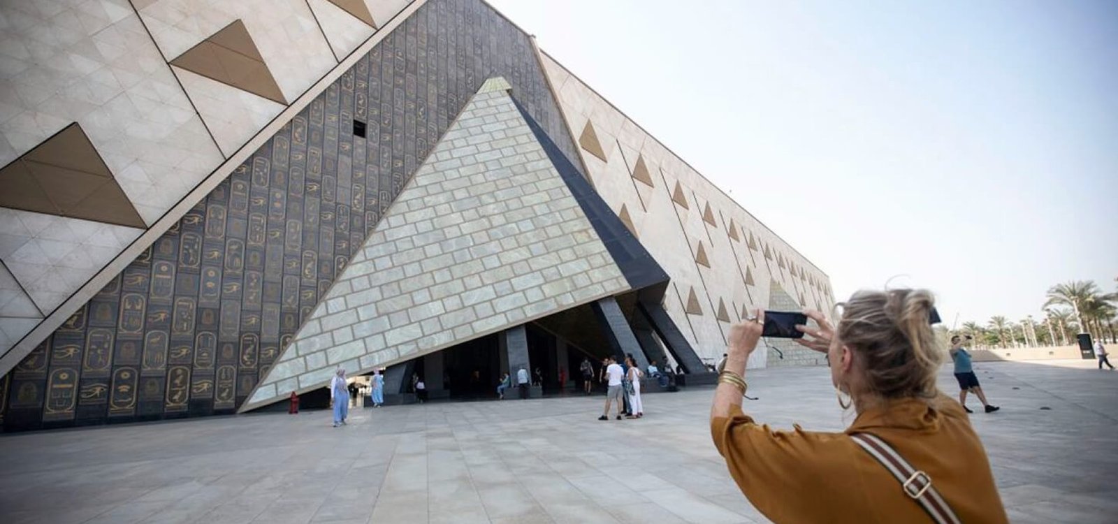 A wonderful picture of a woman in front of the Grand Egyptian Museum