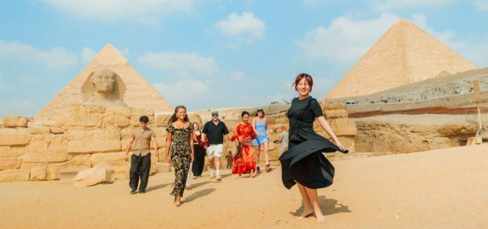 happy tourists at giza pyramids and sphinx