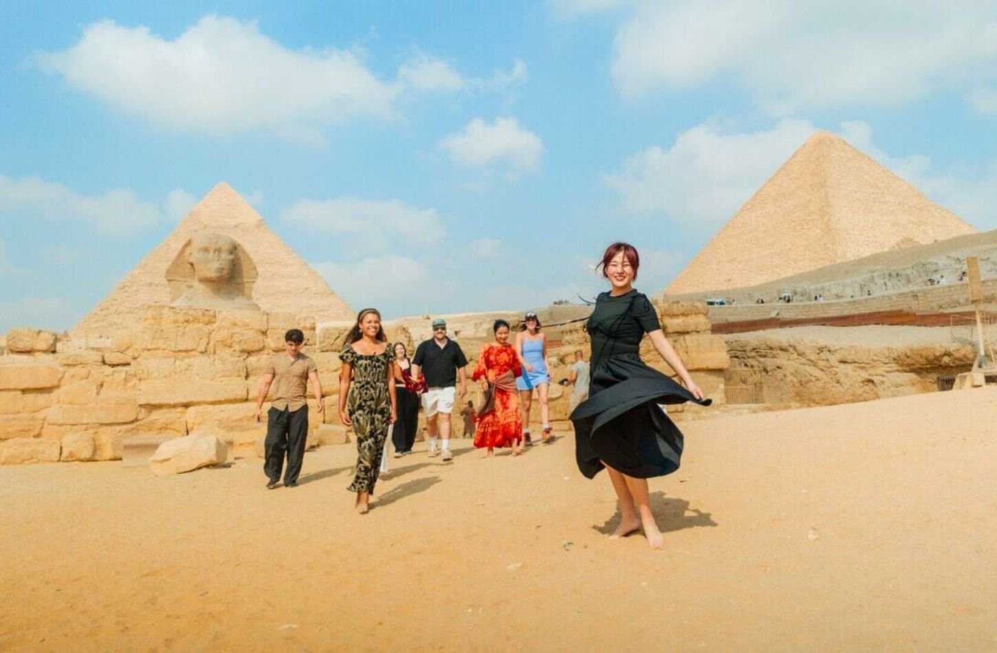 happy tourists at giza pyramids and sphinx